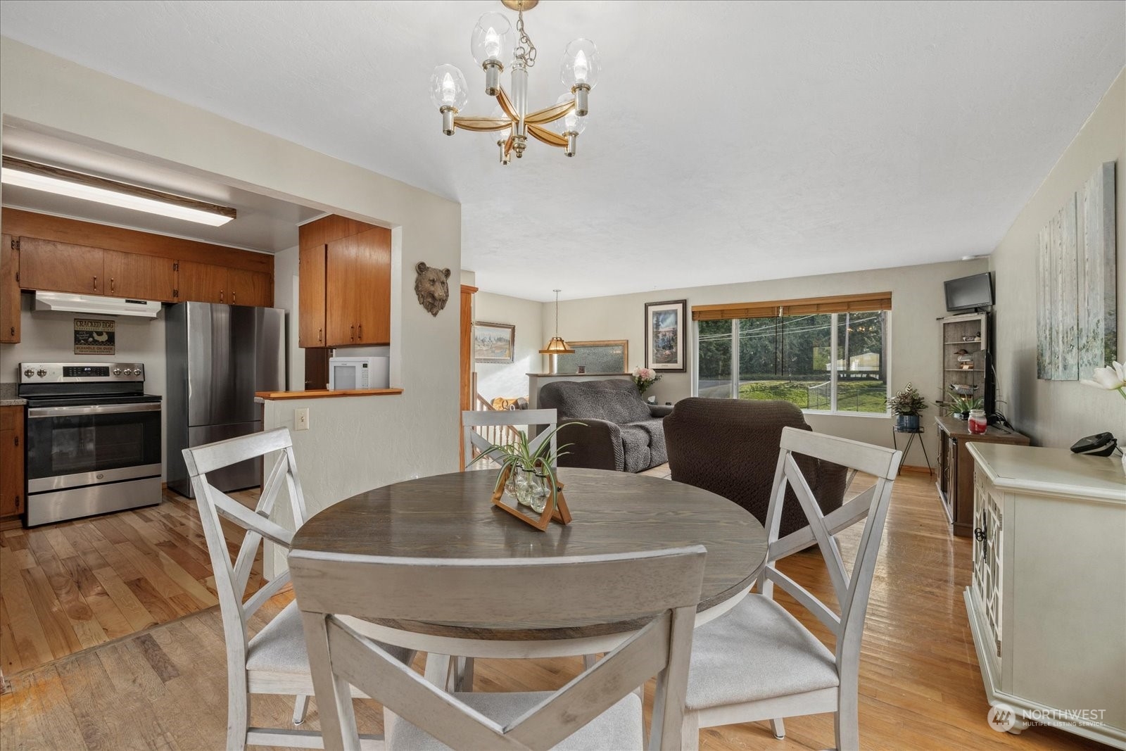 13925 Dubuque Road Snohomish, WA 98290 - Photo 9 of 40 a dining room with furniture a chandelier and wooden floor