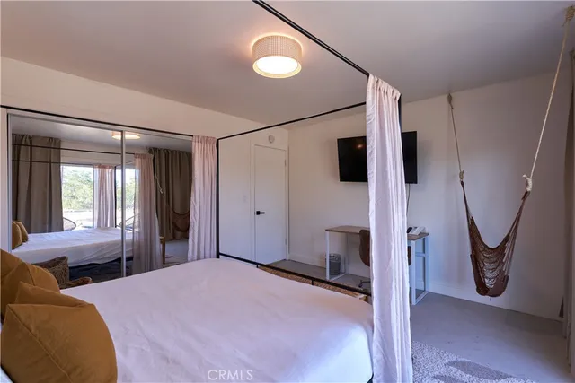 a bedroom with a large bed and a large window