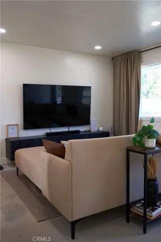 a view of a patio with table and chairs and potted plants