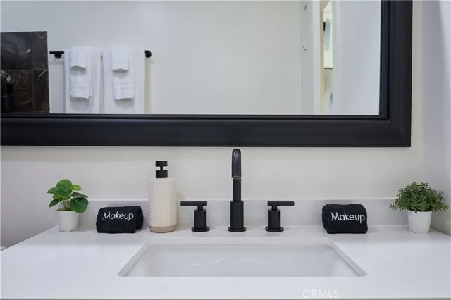 a bathroom with a sink vanity and mirror