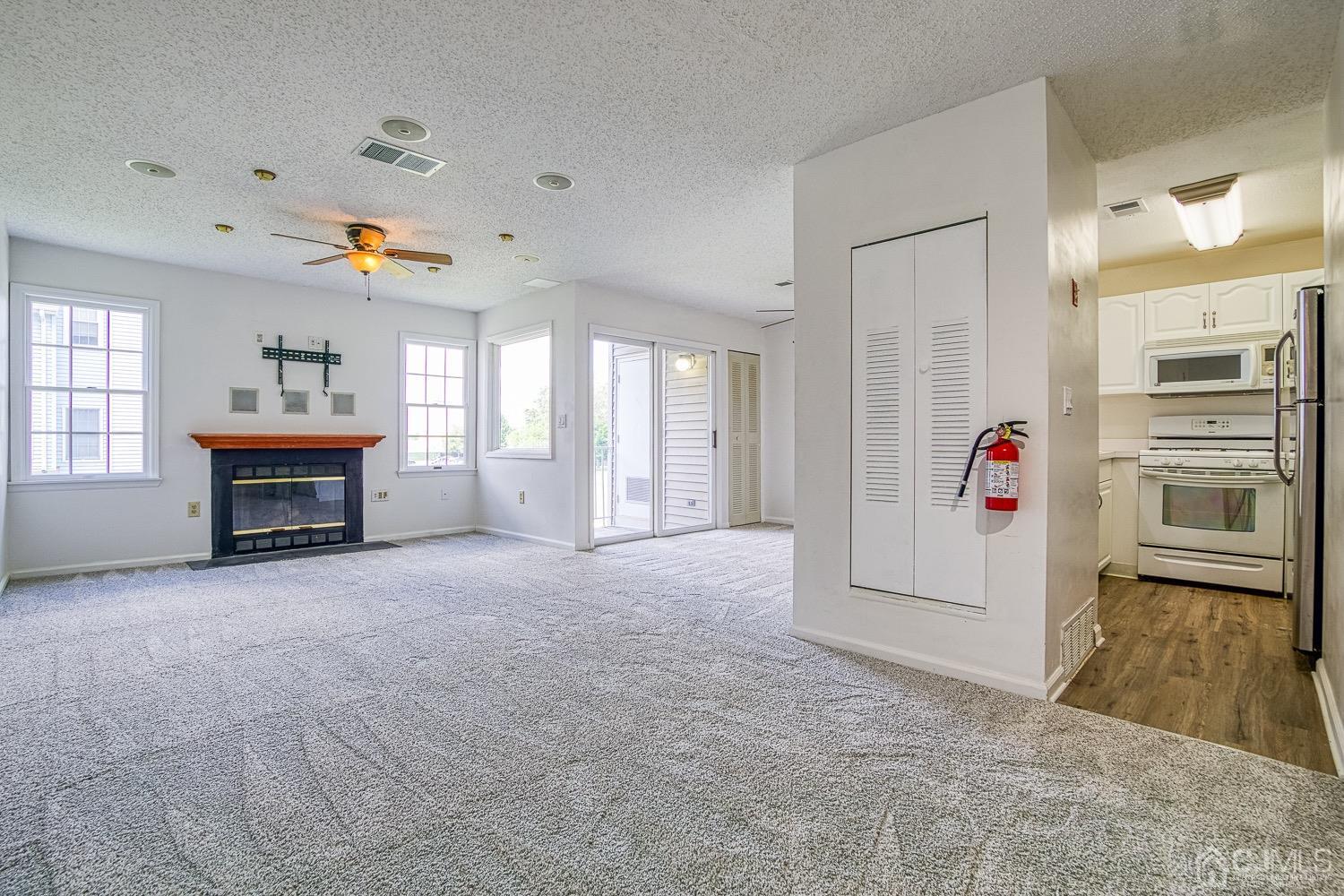 520 Edpas Road New Brunswick, NJ 08901 - Photo 3 of 15 an entryway with fireplace chandelier and windows