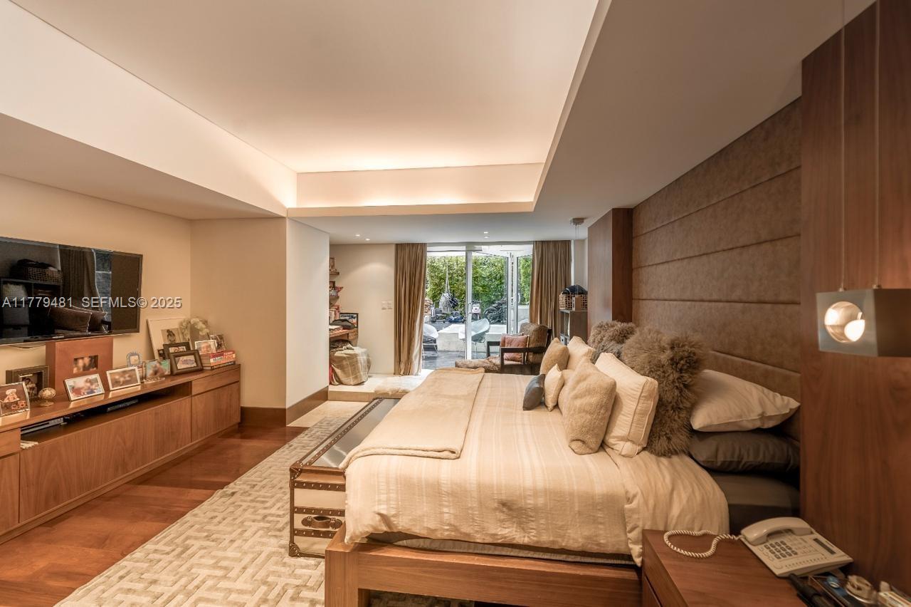 undefined, FL 11000 - Photo 11 of 27 a bedroom with bed and flat tv screen