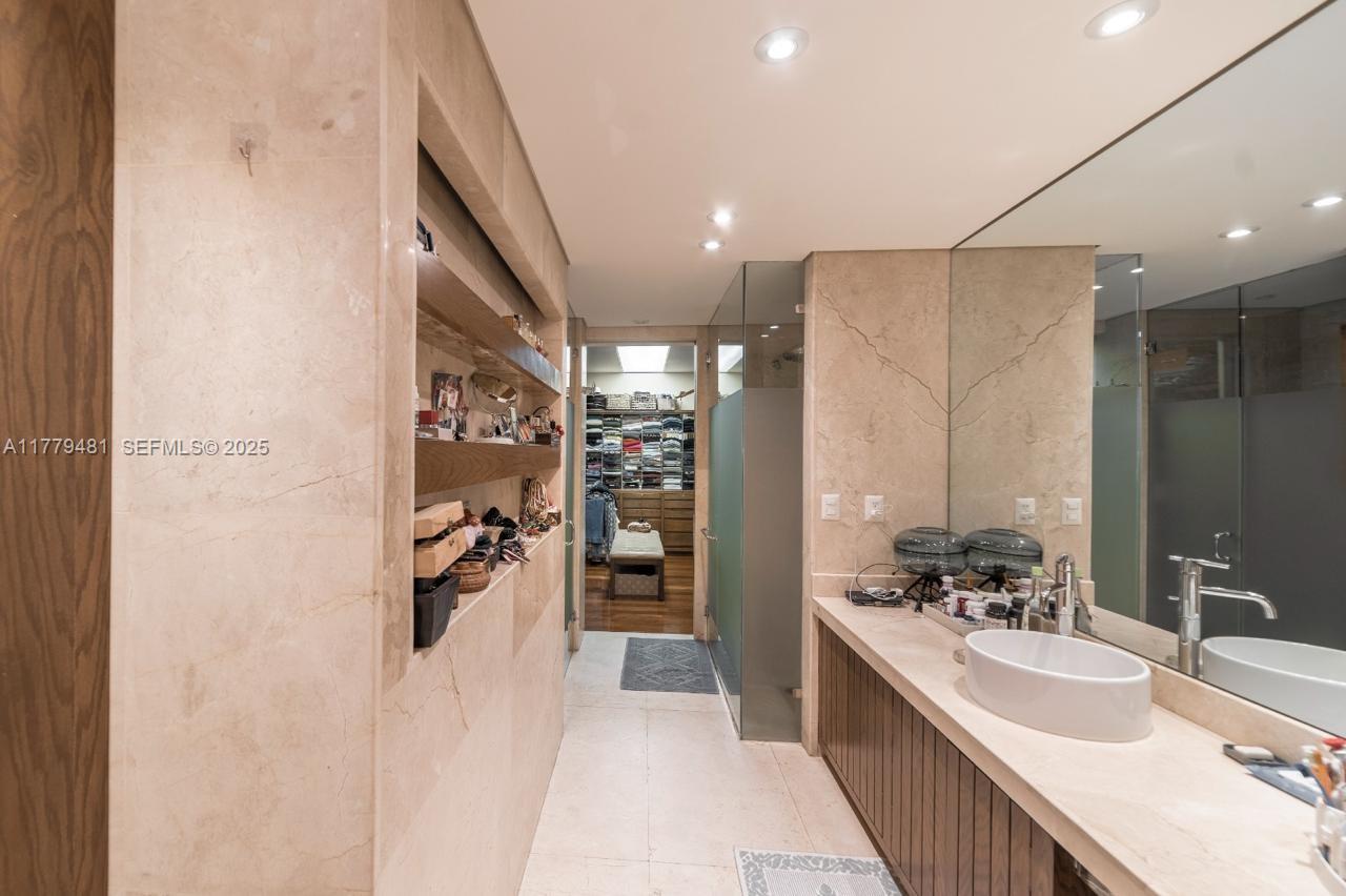 undefined, FL 11000 - Photo 14 of 27 a large white kitchen with a sink and stainless steel appliances