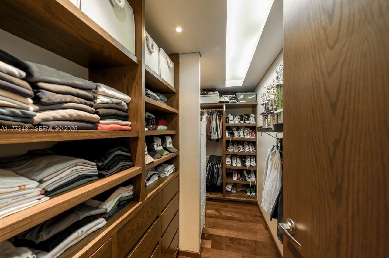 undefined, FL 11000 - Photo 15 of 27 a view of walk in closet with clothes and shoes