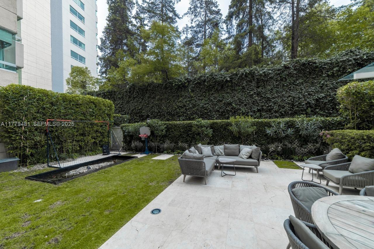 undefined, FL 11000 - Photo 17 of 27 a view of a patio with couches and a table and chairs with wooden fence