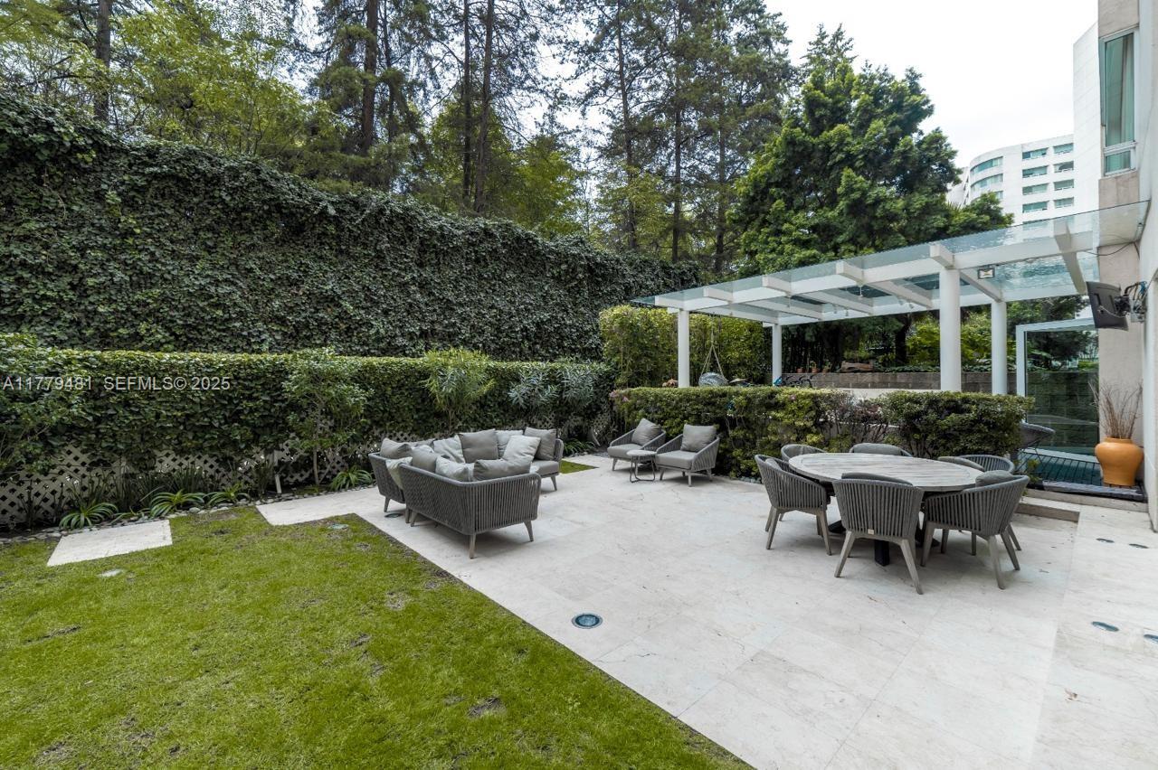 undefined, FL 11000 - Photo 18 of 27 a view of a patio with couches table and chairs and potted plants