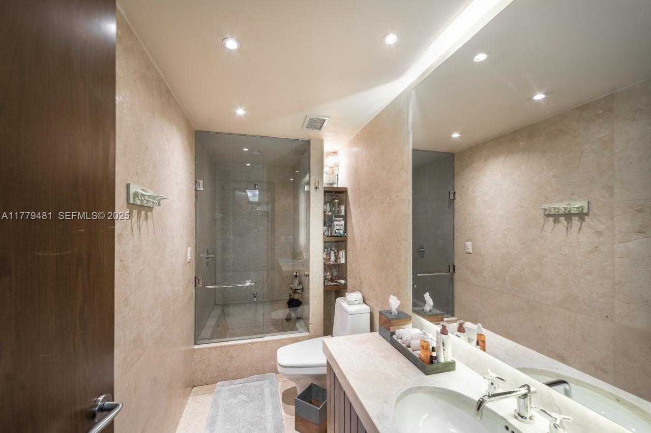 undefined, FL 11000 - Photo 9 of 27 a bathroom with a bathtub shower sink vanity and toilet