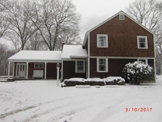a view of a house with a yard covered in snow