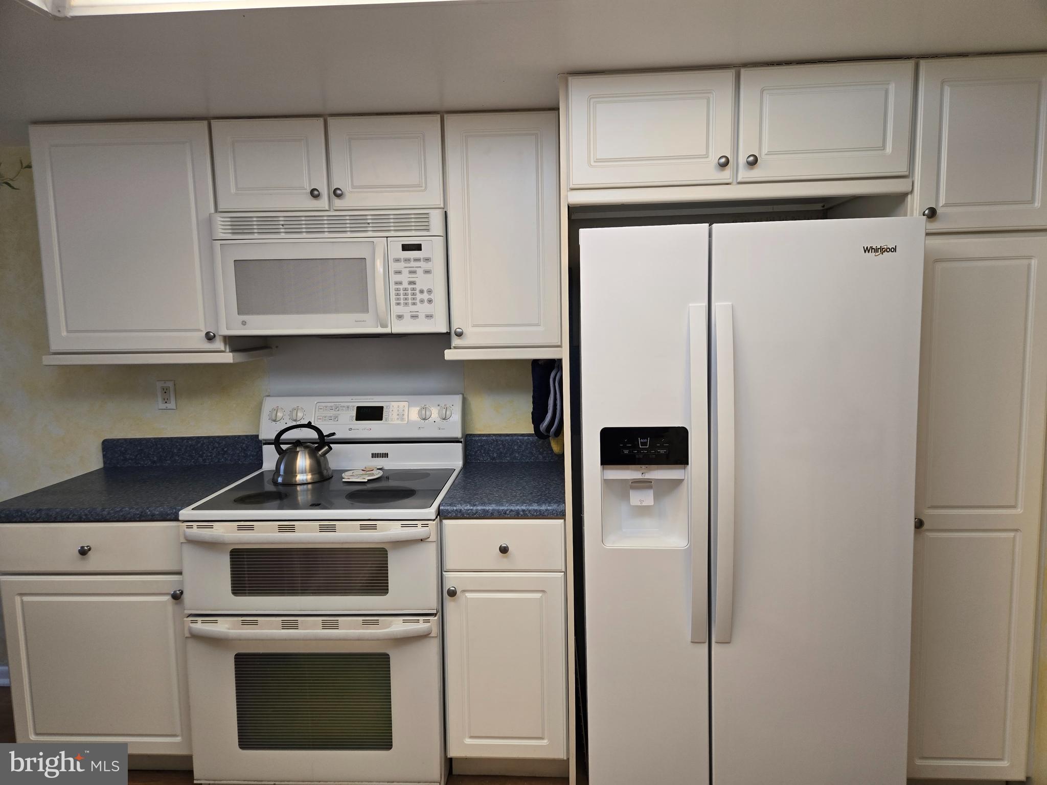 1000 Putnam Boulevard, Unit 603 Wallingford, PA 19086 - Photo 15 of 44 a kitchen with stainless steel appliances white cabinets and a refrigerator