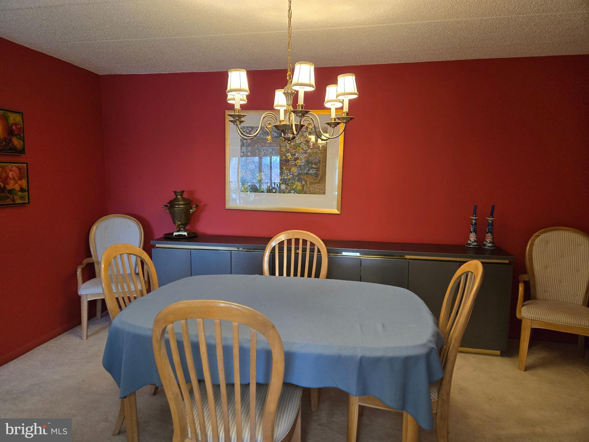 1000 Putnam Boulevard, Unit 603 Wallingford, PA 19086 - Photo 19 of 44 a view of a dining room with furniture and chandelier