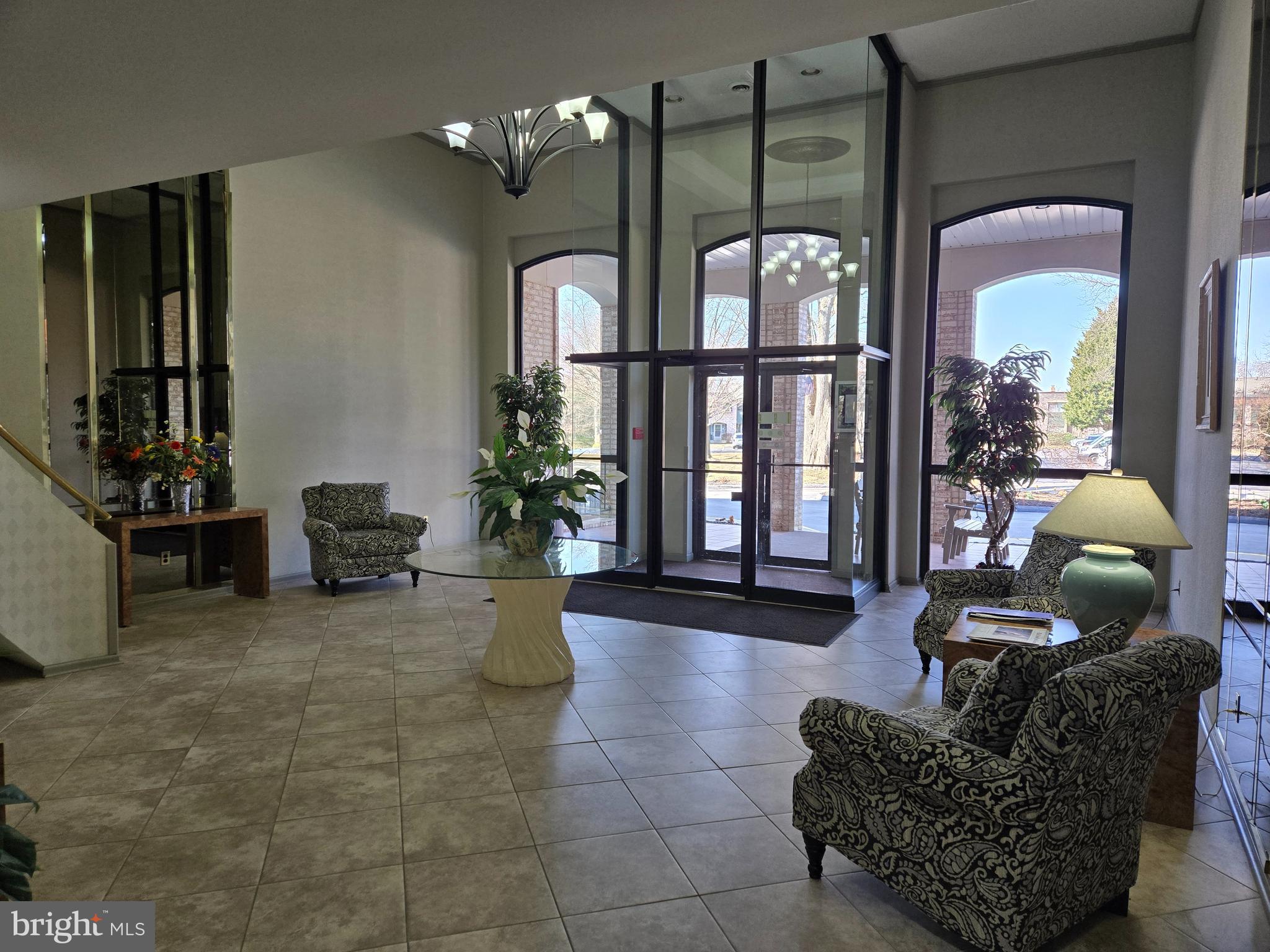 1000 Putnam Boulevard, Unit 603 Wallingford, PA 19086 - Photo 4 of 44 a living room with furniture and a floor to ceiling window