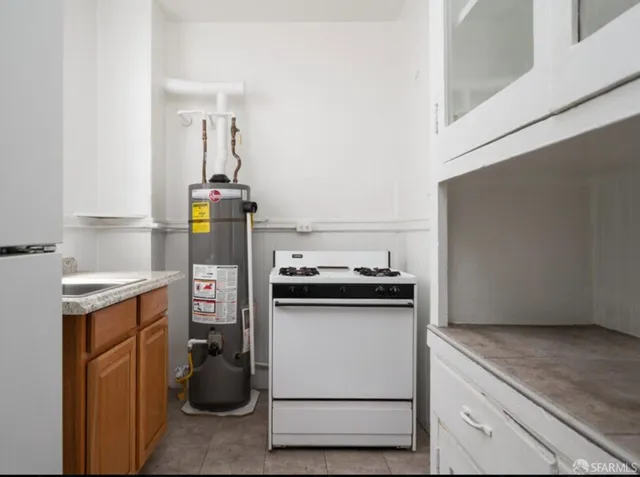 a kitchen with a stove and a refrigerator