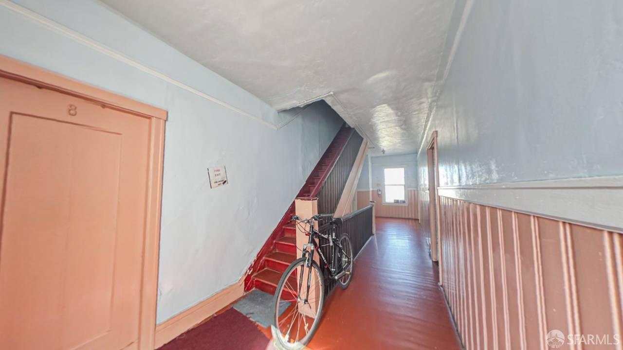 480-484 6th Street San Francisco, CA 94103 - Photo 20 of 52 a view of a hallway with wooden floor and stairs