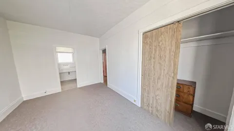 a view of empty room with closet and entryway
