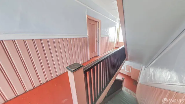 a view of a hallway with stairs