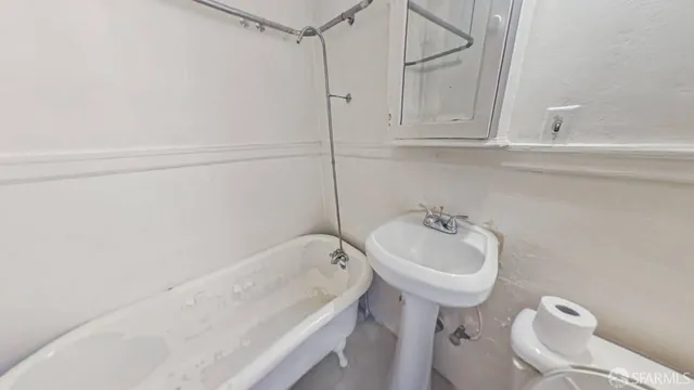 a bathroom with a sink a toilet and bathtub
