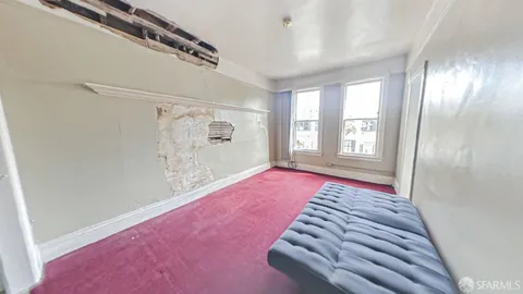 a view of an empty room with windows