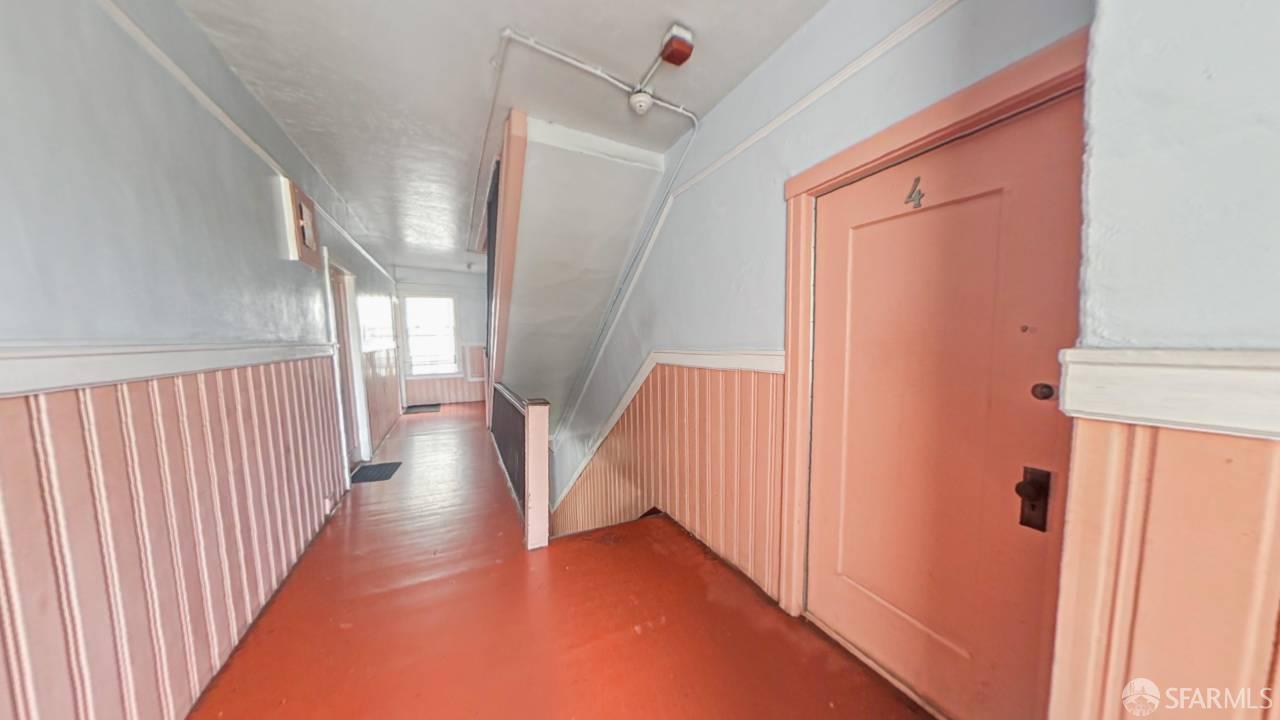 480-484 6th Street San Francisco, CA 94103 - Photo 35 of 52 a view of a hallway with wooden floor and staircase