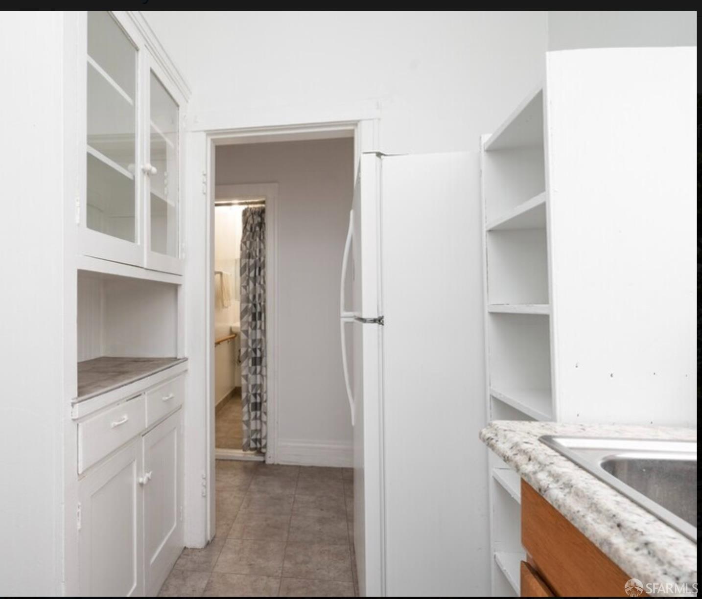 480-484 6th Street San Francisco, CA 94103 - Photo 9 of 52 a kitchen with white cabinets and refrigerator
