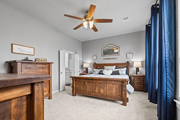 a bedroom with a bed and a chandelier