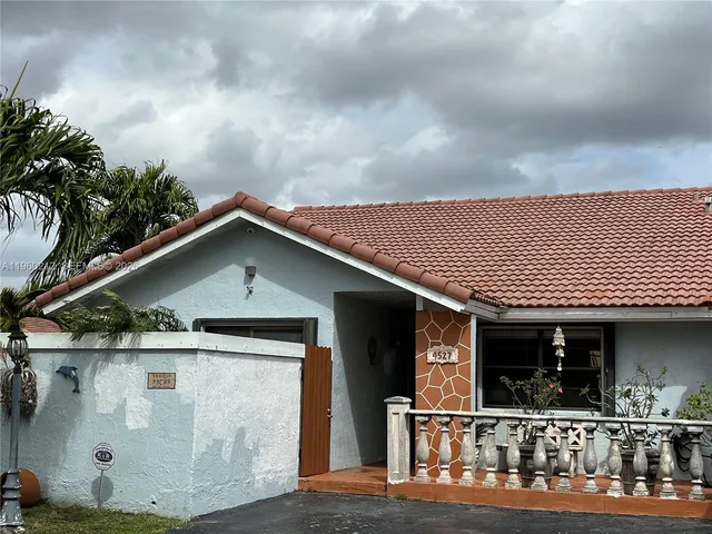 a front view of a house with yard
