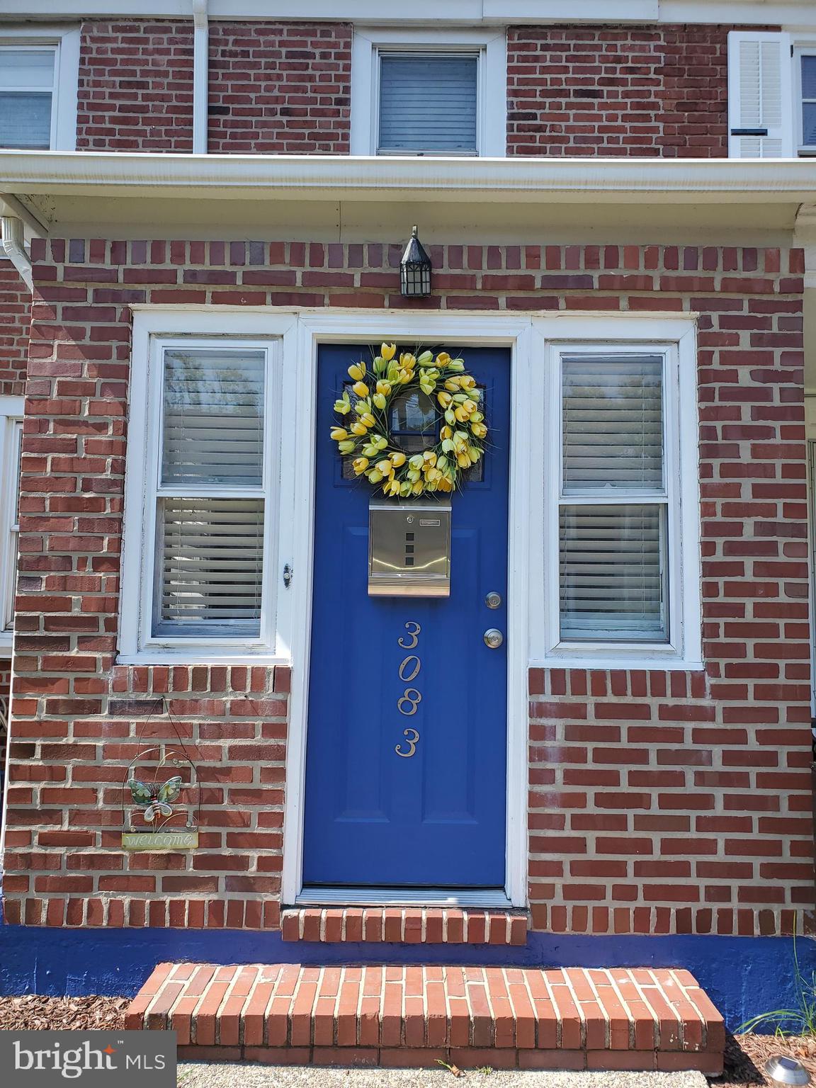 Lovely, inviting brick facade & cobalt blue door!