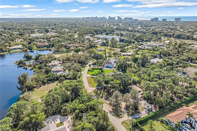 an aerial view of a houses with a lake