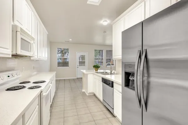 a kitchen with a sink stove and refrigerator