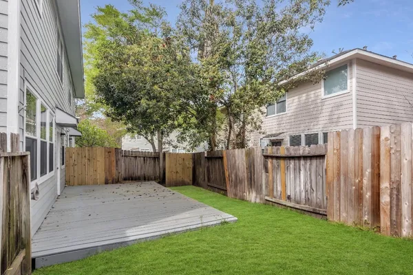 a front view of a house with a yard and tree