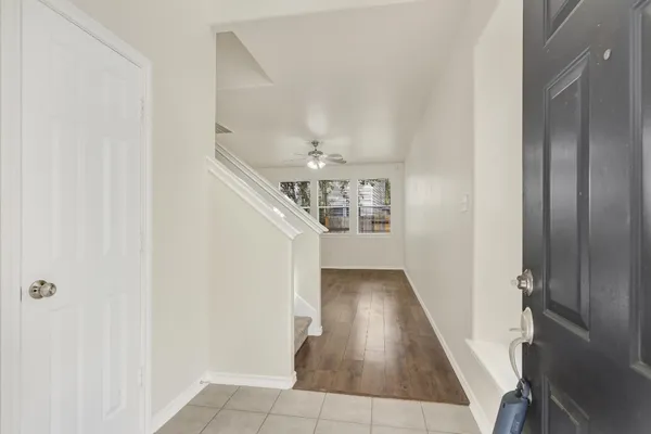 a view of entryway and hall with wooden floor