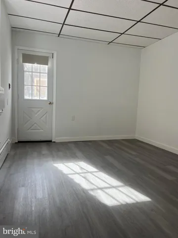 a view of a room with wooden floor and cabinet