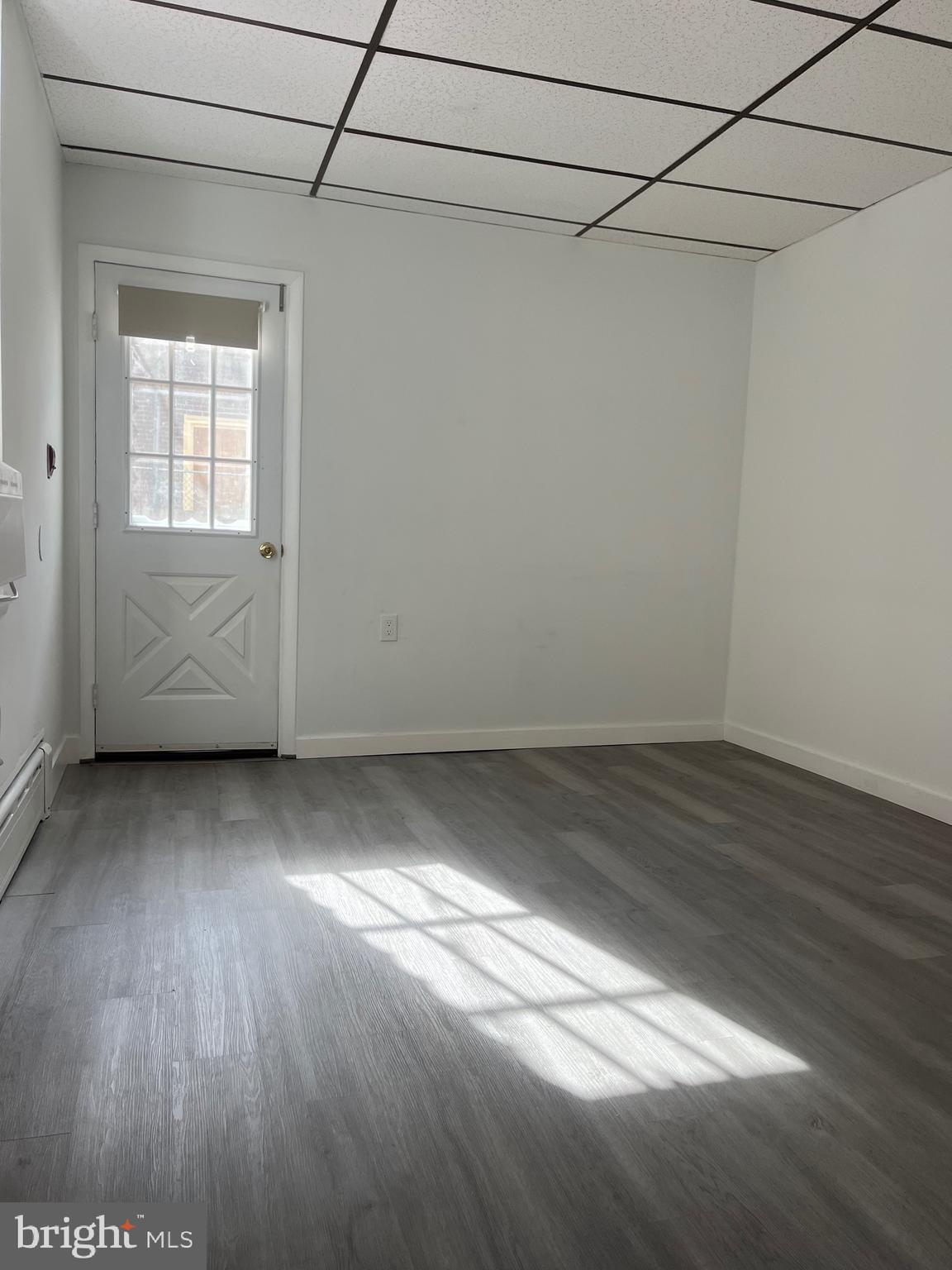 1304 Jackson Street, Unit 1 Philadelphia, PA 19148 - Photo 13 of 17 a view of a room with wooden floor and cabinet