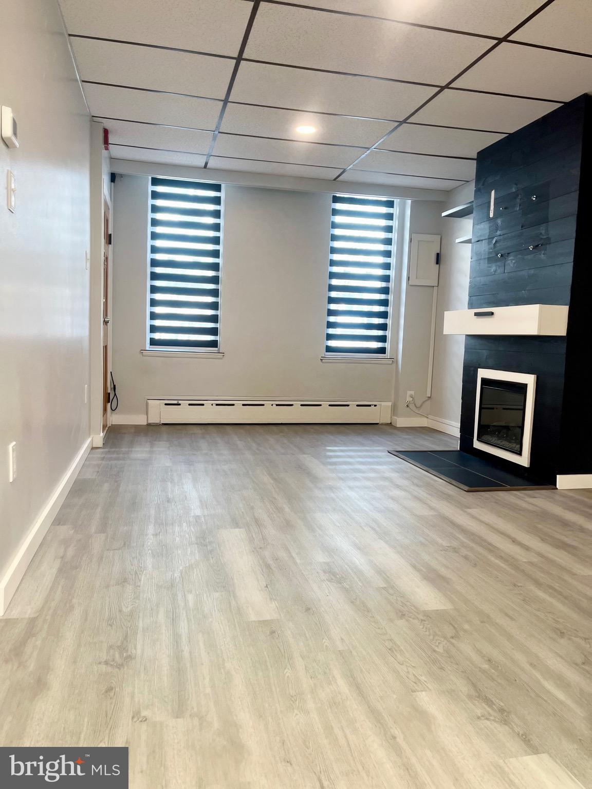 1304 Jackson Street, Unit 1 Philadelphia, PA 19148 - Photo 2 of 17 a view of empty room with a fireplace and window
