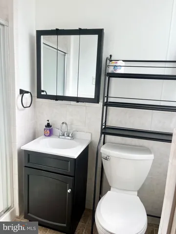 a bathroom with a toilet sink and mirror