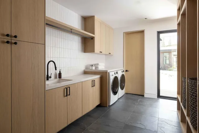 a view of a kitchen with sink washer and dryer