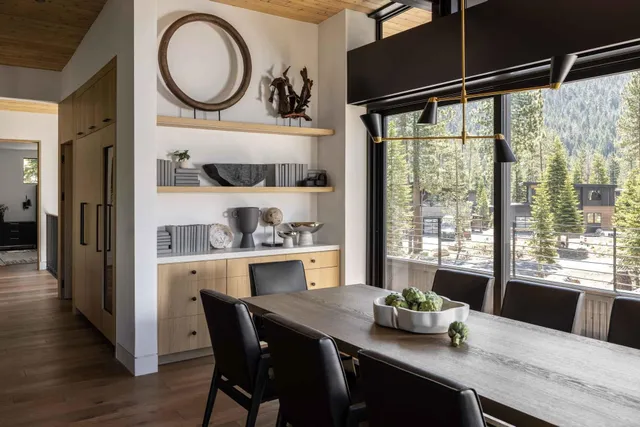 a kitchen with a table chairs a window and appliances