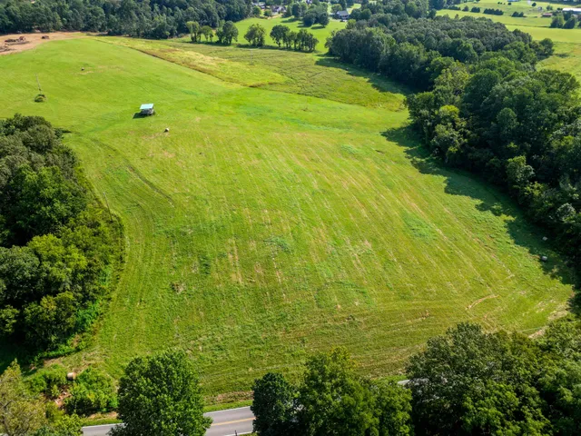 a view of a large yard with lots of green space and mountain view