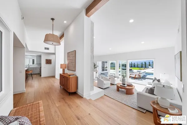 a kitchen with a dining table chairs stainless steel appliances and cabinets