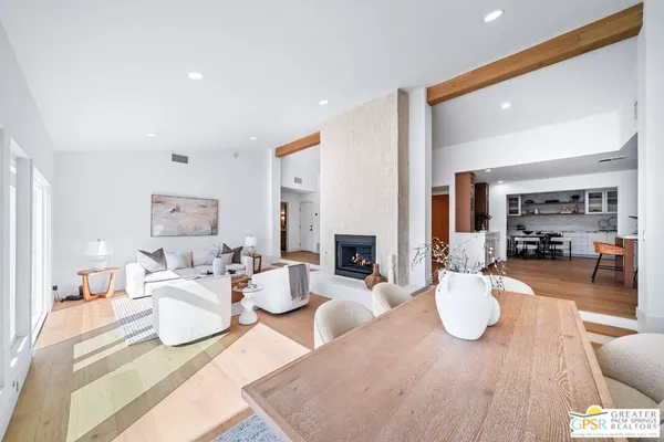 a bedroom with furniture and a wooden floor