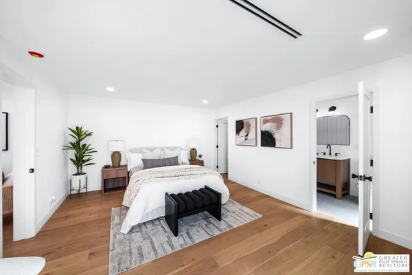 a bedroom with furniture and a wooden floor
