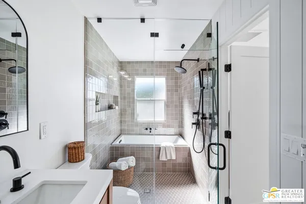 a bathroom with a sink a mirror and a shower