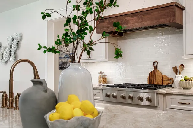 a large kitchen with kitchen island a island a sink a stove and a refrigerator