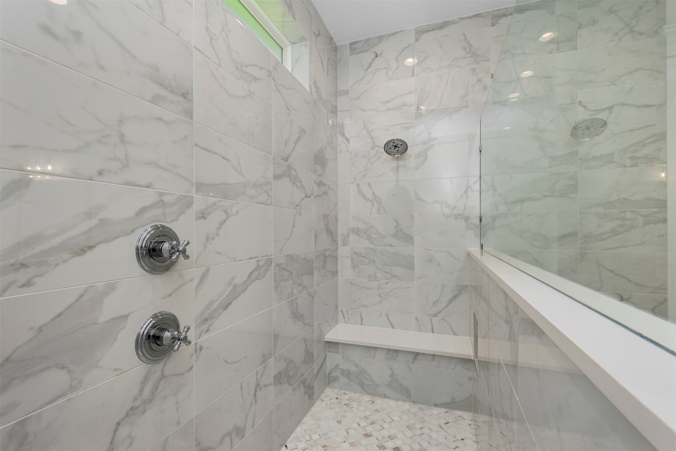 630 Lonestar Road Huntsville, TX 77340 - Photo 32 of 48 Large rectangle tile on walls (floor to ceiling) and patterned marble floors are high end finishes in primary shower.