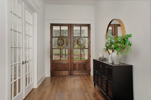 a living room with furniture fireplace and a large window