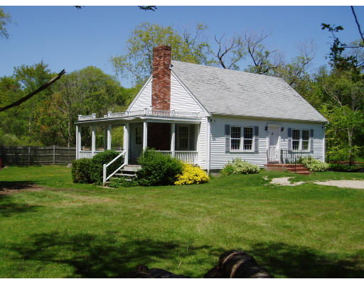 1 Orchard Road Gloucester, MA 01930 - Photo 2 of 2 a front view of a house with a yard table and chairs