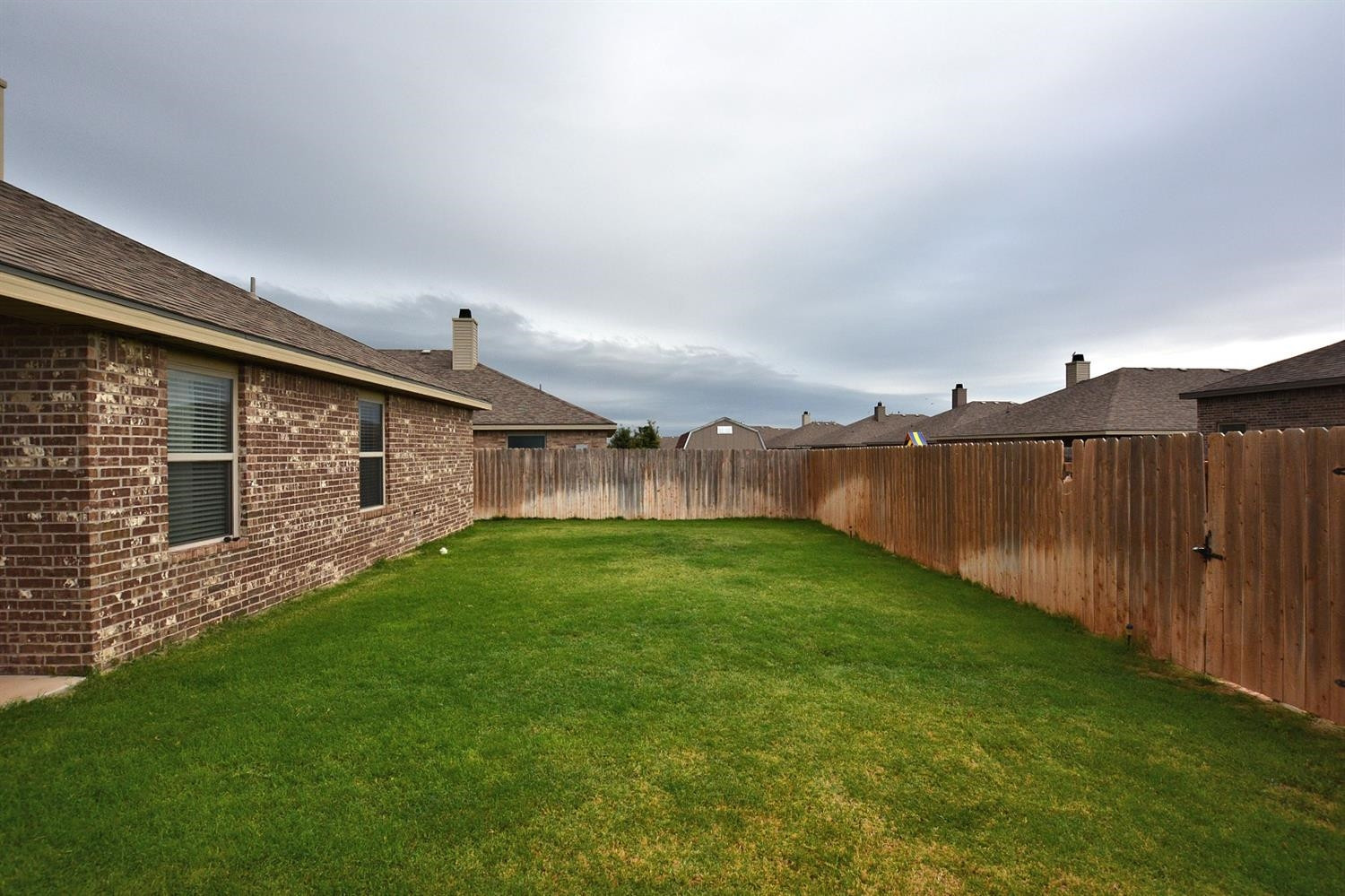 3703 Rochester Avenue Lubbock, TX 79407 - Photo 20 of 20 a view of a backyard with wooden fence
