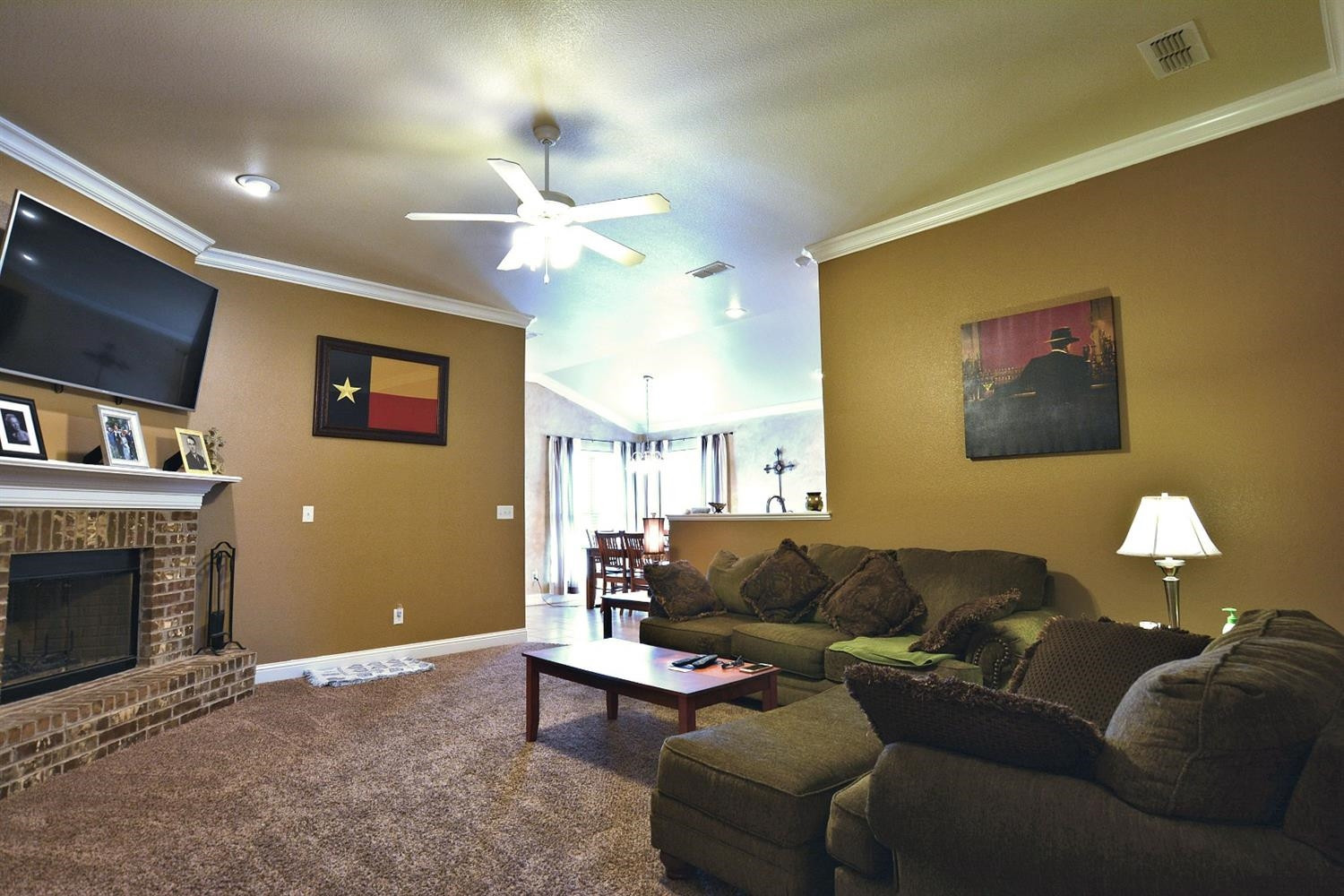 3703 Rochester Avenue Lubbock, TX 79407 - Photo 3 of 20 a living room with furniture a fireplace and a flat screen tv