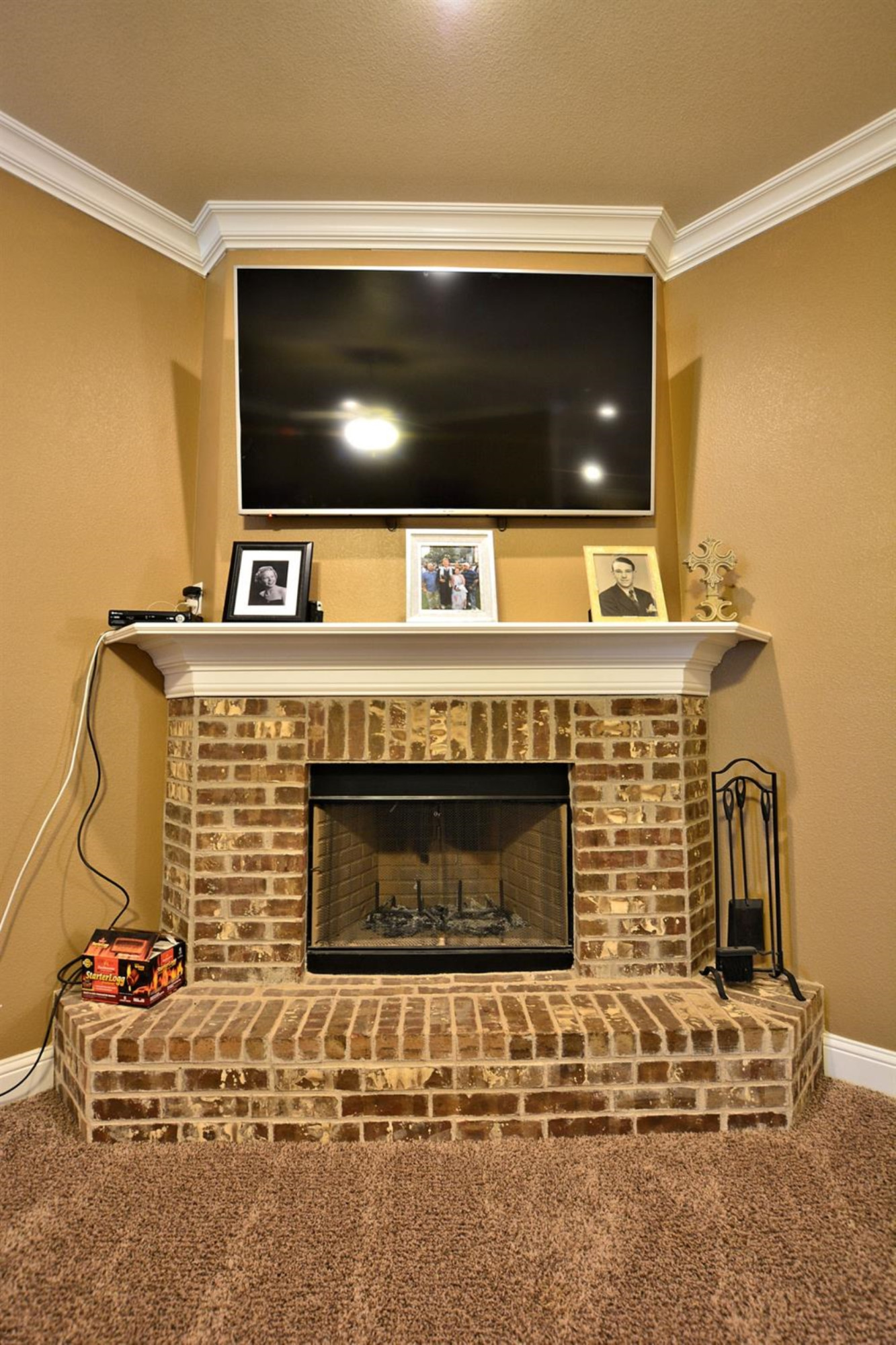 3703 Rochester Avenue Lubbock, TX 79407 - Photo 4 of 20 a fireplace with a flat screen tv