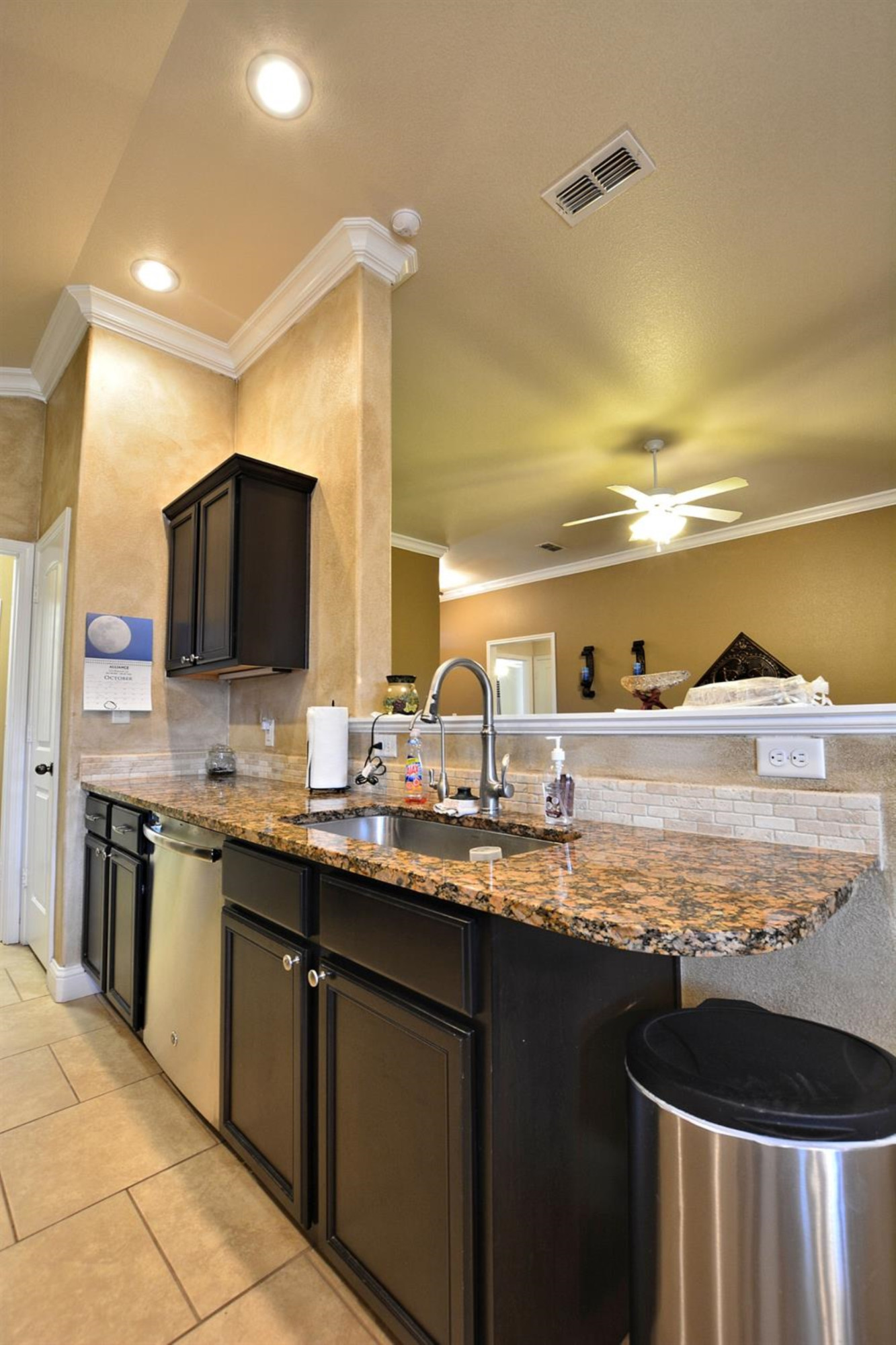 3703 Rochester Avenue Lubbock, TX 79407 - Photo 8 of 20 a kitchen with kitchen island granite countertop a sink and a stove