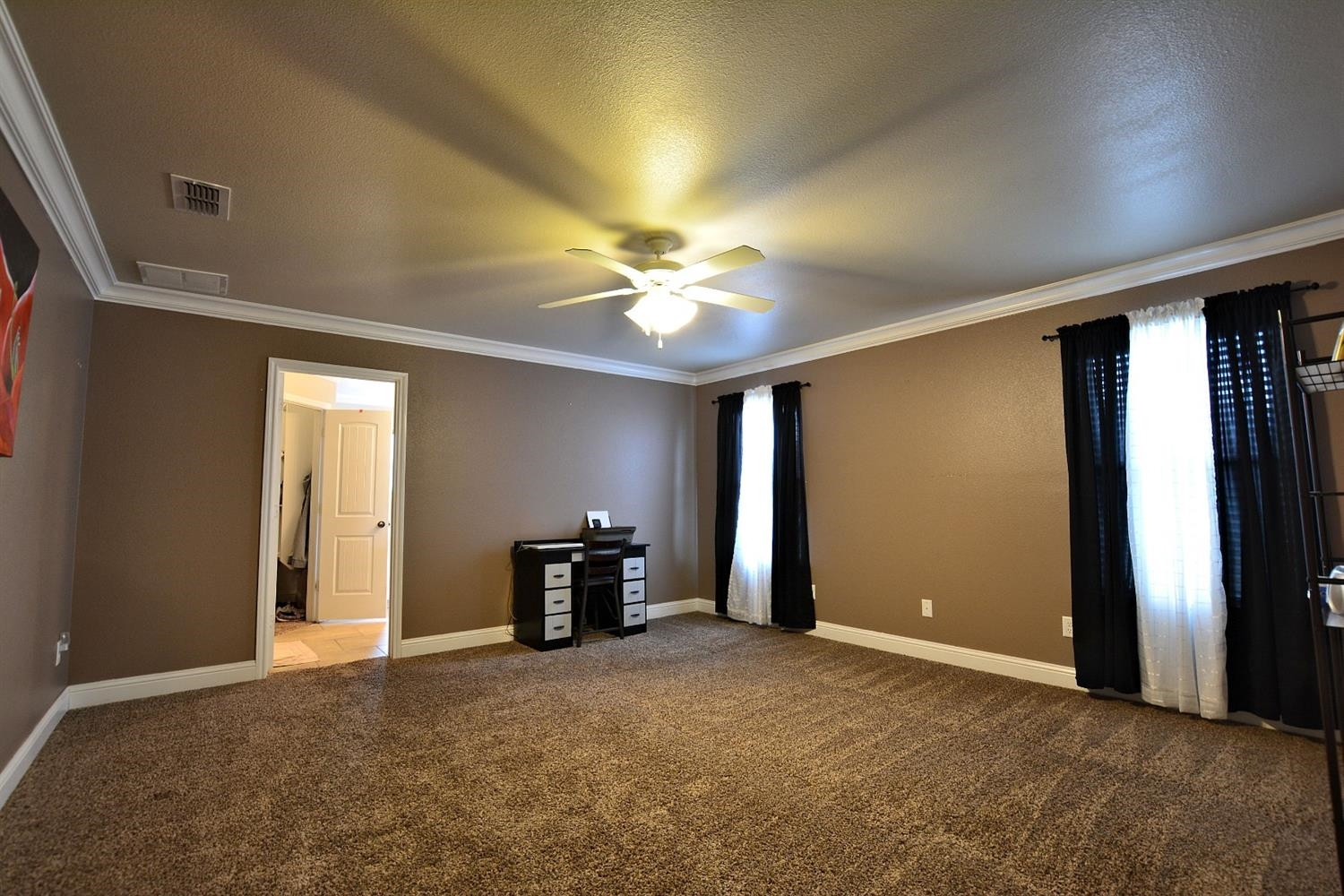 3703 Rochester Avenue Lubbock, TX 79407 - Photo 10 of 20 an empty room with fan and windows